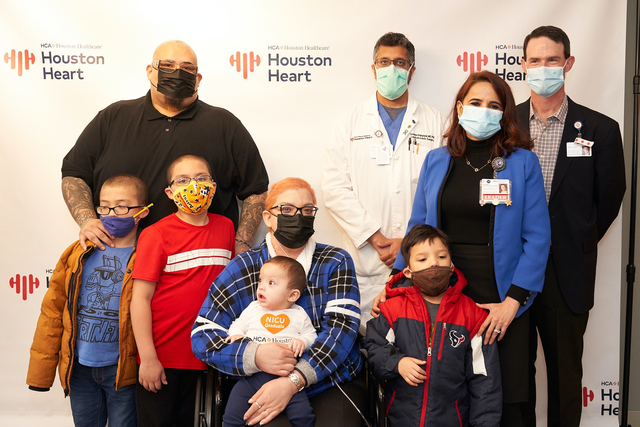 Crystal Gutierrez Reunites with Caregivers from HCA Houston Healthcare Medical Center and Houston Heart after battling COVID-19 for 152 Days in the hospital. Pictured back row: Rafael Gutierrez, Crystal’s husband, Dr. Keshava Rajagopal with Houston Heart, Puneet Friebott, CNO at HCA Houston Healthcare Medical Center and Peyton Elliott, CEO at HCA Houston Healthcare Medical Center. Front row: Crystal Gutierrez (seated) and her four sons.