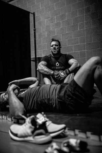 MMA Champion Ryan Bader trains for a match wearing a Get BioFuel shirt