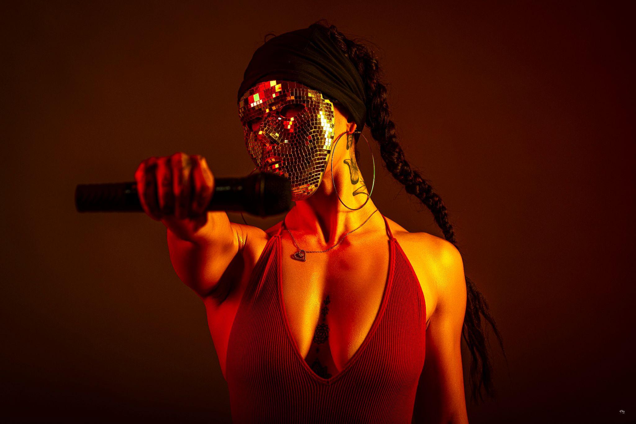 Atlanta-based independent artist ASKYE features her signature mirror-mask, symbolizing reflection and connection through her music.
