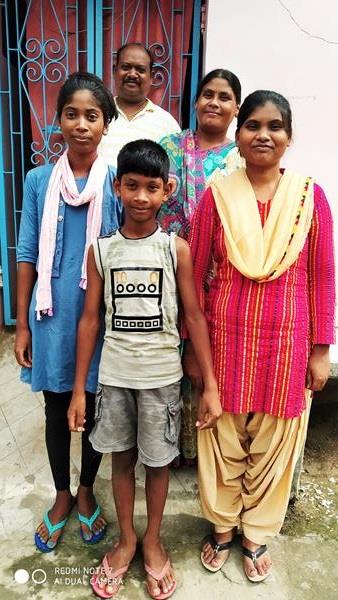 Pinky (far right) and her siblings, Peter and Mary, stand with their parents, Ursula and Jawahar, in front of their home in India. Pinky was sponsored by Unbound in 2003, when she was 6. She lives near Bhagalpur, India, and recently completed a nursing internship – an accomplishment that likely would not have been possible without support from Unbound. 