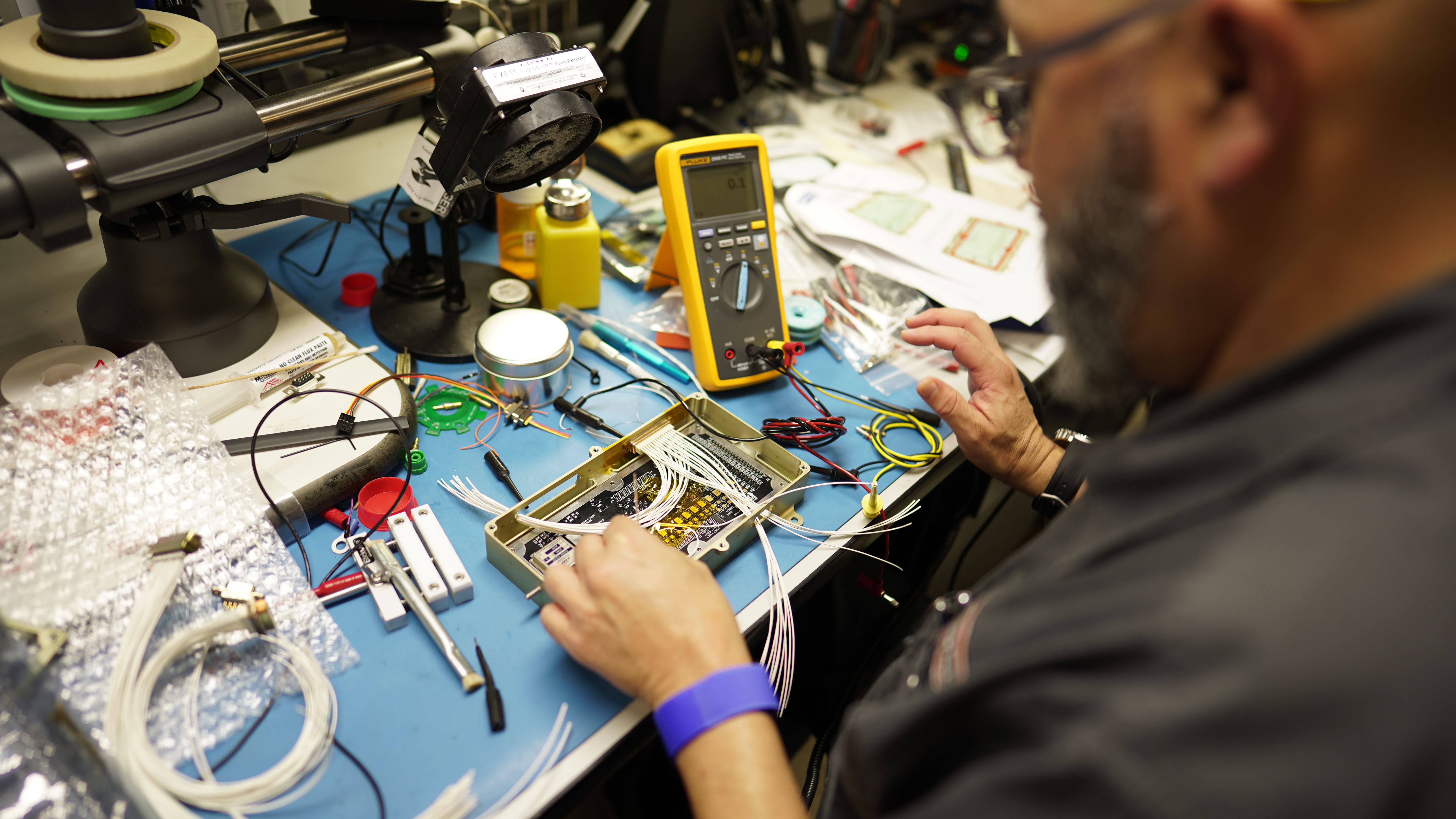 An Intuitive Machines engineer prepares a printed circuit board for testing
