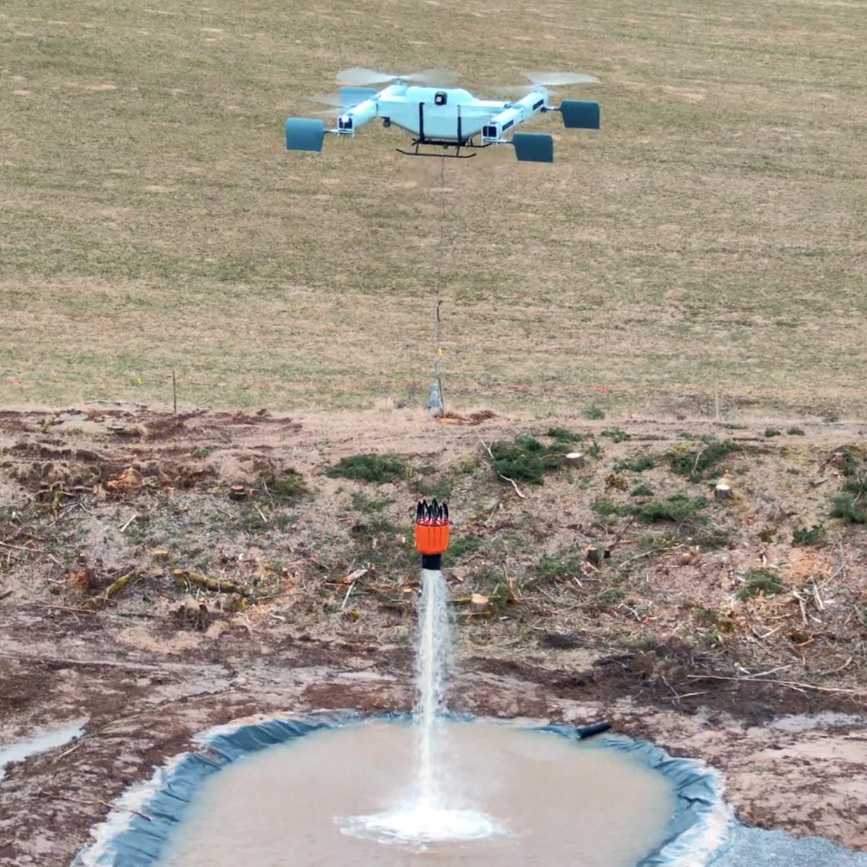 The FireSwarm ACC Thunderwasp Heavy-Lift Drone buckets water with medium sized Bambi Bucket during test flight.