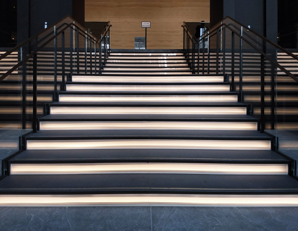 Nearly 2,700 square feet of architectural glass from Bendheim was installed in a major renovation project at Willis Tower in Chicago. Bendheim backlit laminated glass is installed in this section to create the illuminated stairs. Photo courtesy of Bendheim.
