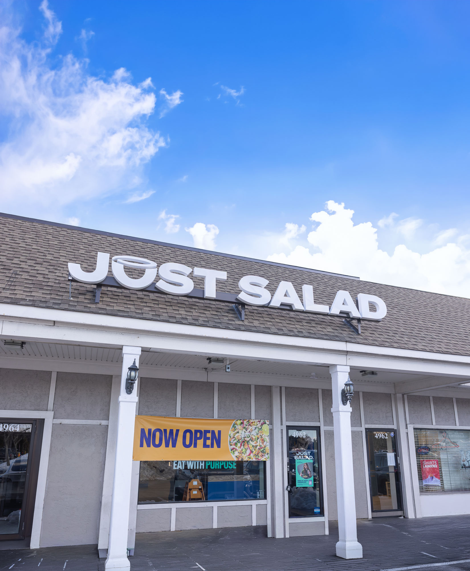 Exterior storefront of Just Salad located at 4962 Merrick Road in Massapequa Park, New York