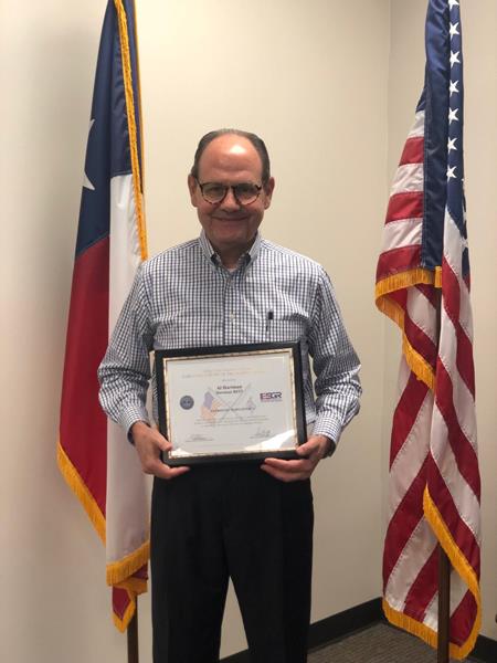 Al Hartman, CEO of Hartman Companies, poses for a picture with his Patriot Award. 