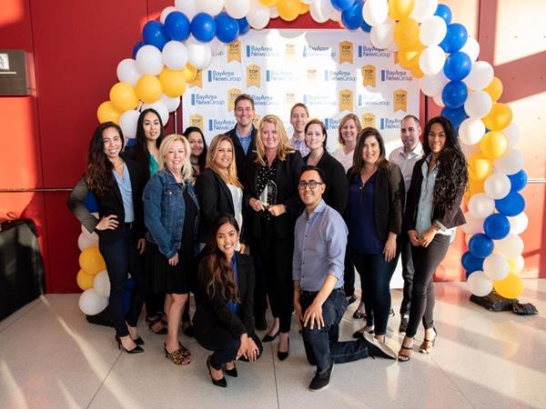 Aimco’s Vice President of Operations, Sandy McClure, holds the award surrounded by members of the Bay Area Operations and HR teams.
