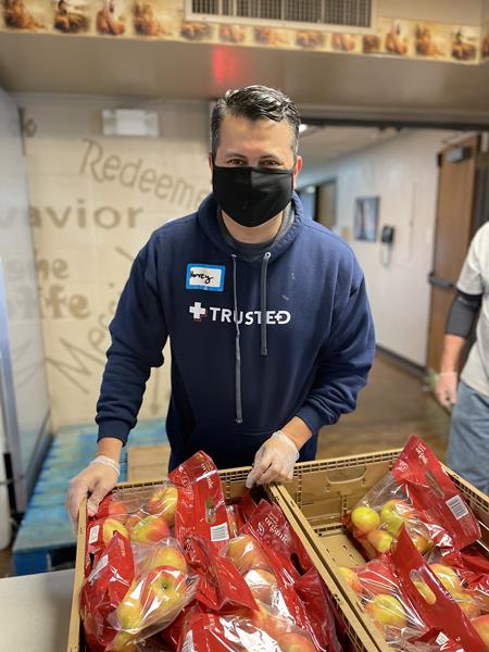 Trusted Medical co-founder and President, Harvey Castro, MD sorts food items at Community Table food pantry in North Richland Hills on MLK National Day of Service as part of a nationwide effort to honor the legacy of Dr. Martin Luther King Jr. 