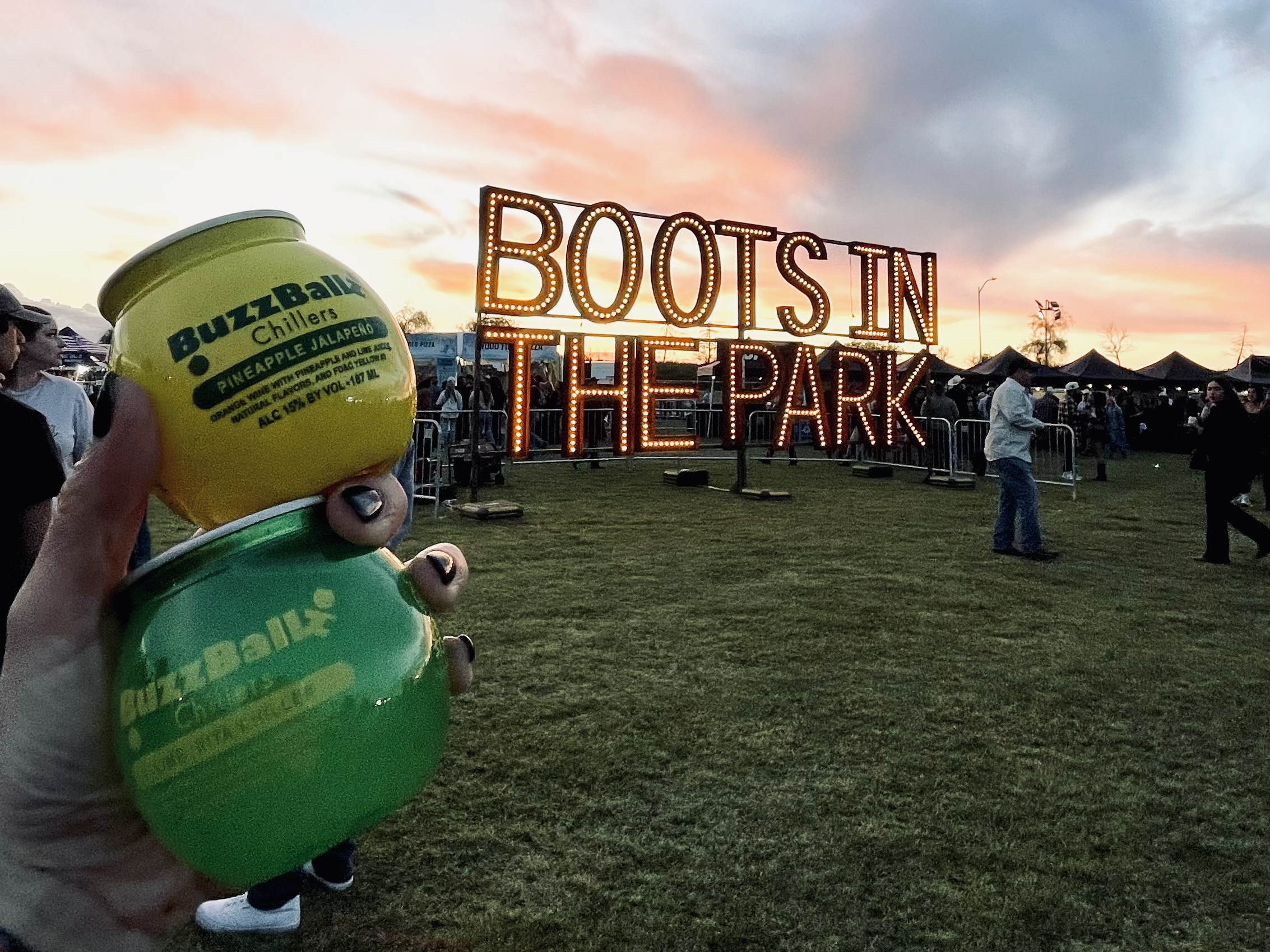 A festival-goer holds two BuzzBallz at a Boots in the Park country music festival put on by Activated Events.