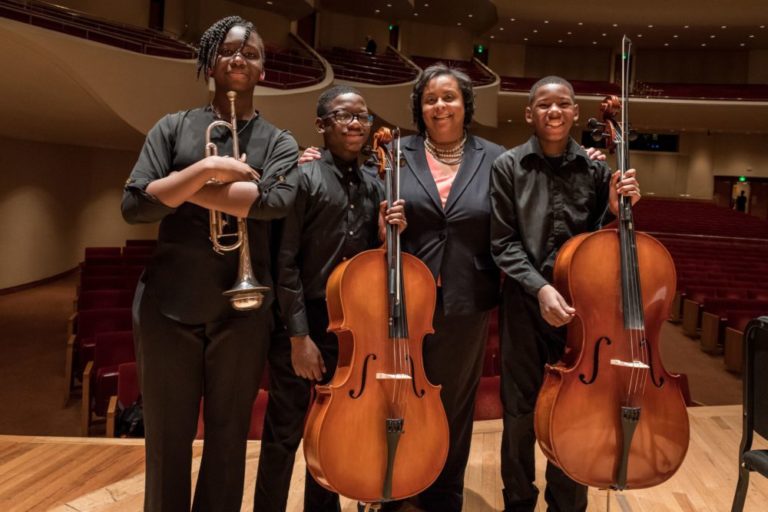 Raquel Whiting Gilmer with OrchKids students 