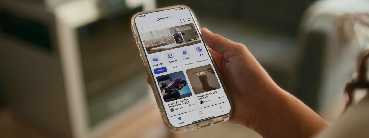 Hand holding smartphone displaying QIDI Maker app interface