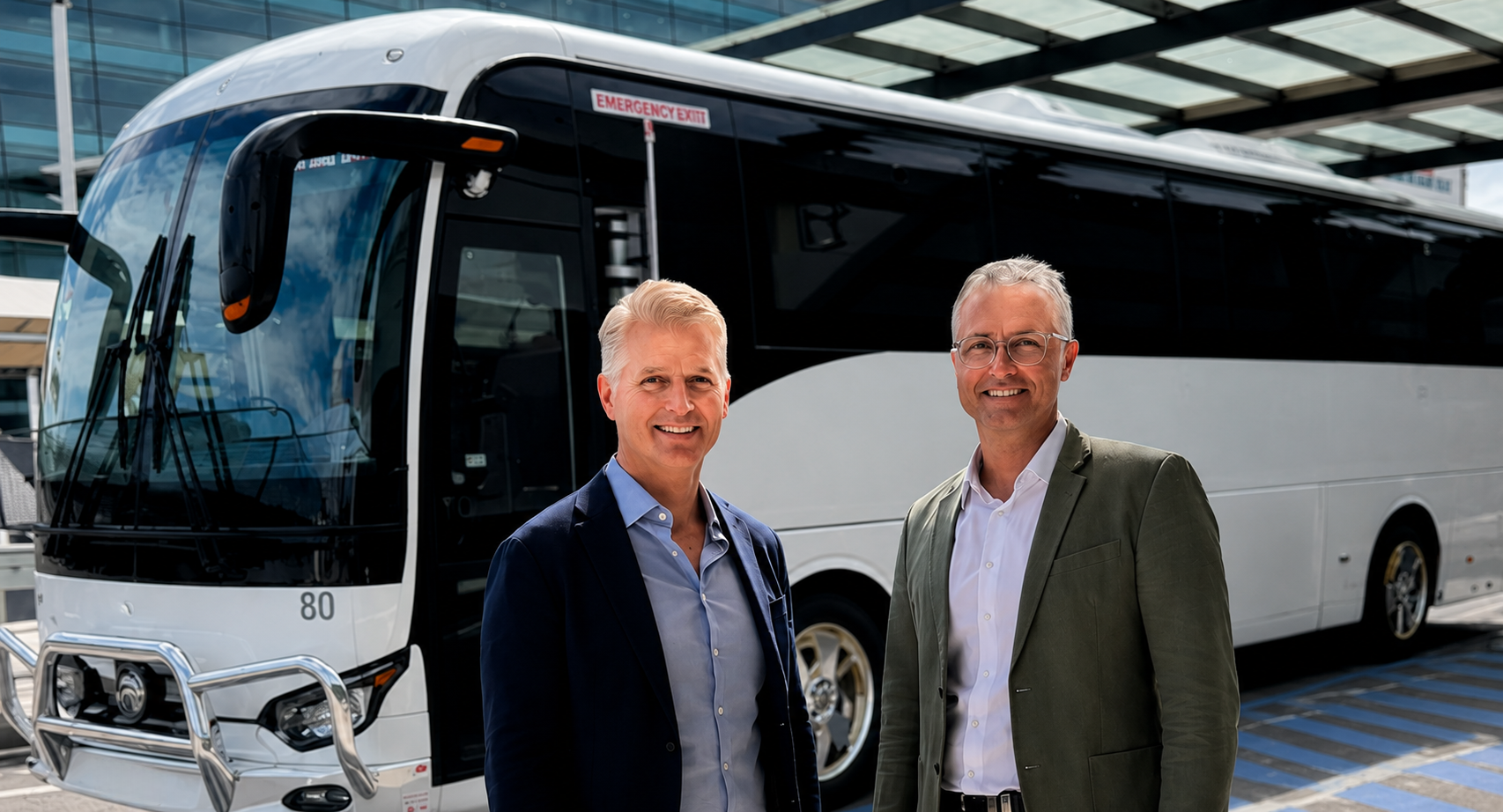 Harald Cruz and Wade O'Shea, CEOs of BusBank and BusCharter.com.au, standing together outside Sydney Airport.