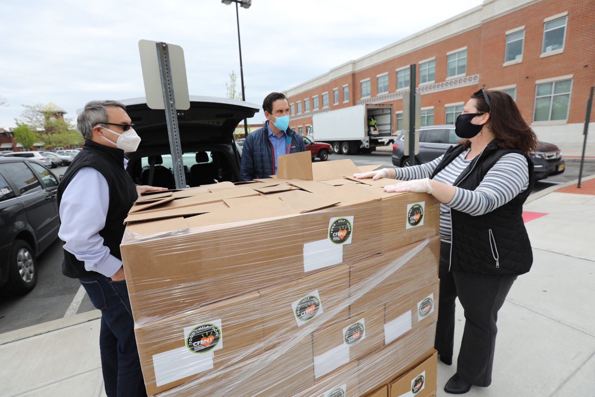 The Community FoodBank of New Jersey has partnered with LogistiCare to safely deliver nonperishable food packages to seniors and other vulnerable Jersey City residents impacted by COVID-19. From left to right: Carlos Rodriguez, President and CEO of the Community FoodBank of New Jersey; Steven Fulop, Jersey City Mayor; Stacey Flanagan, Director of the Jersey City Department of Health and Human Services. 