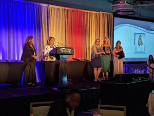 BSM Chief Technical Officer and cofounder, Andrea Wagner, collects her award at the 2022 Enterprising Women of the Year awards ceremony in Clearwater Beach, Florida