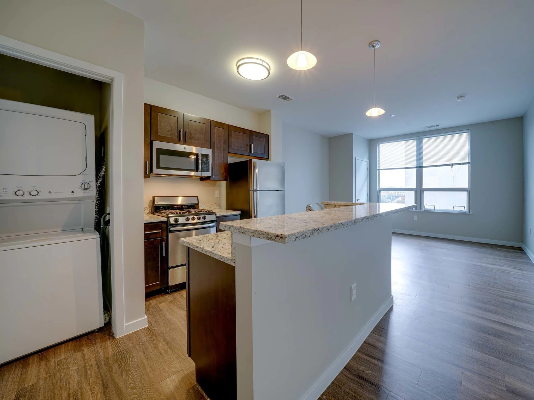 Spacious apartment interior at College & Crown with large windows and modern design.