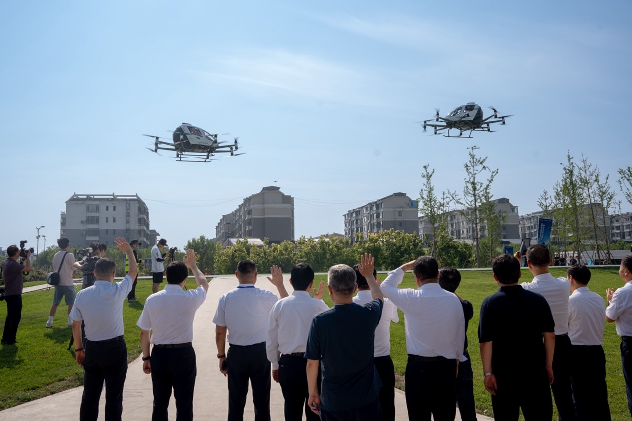 Attendees witness two units of EH216-S pilotless eVTOL taking off simultaneously with four passengers onboard