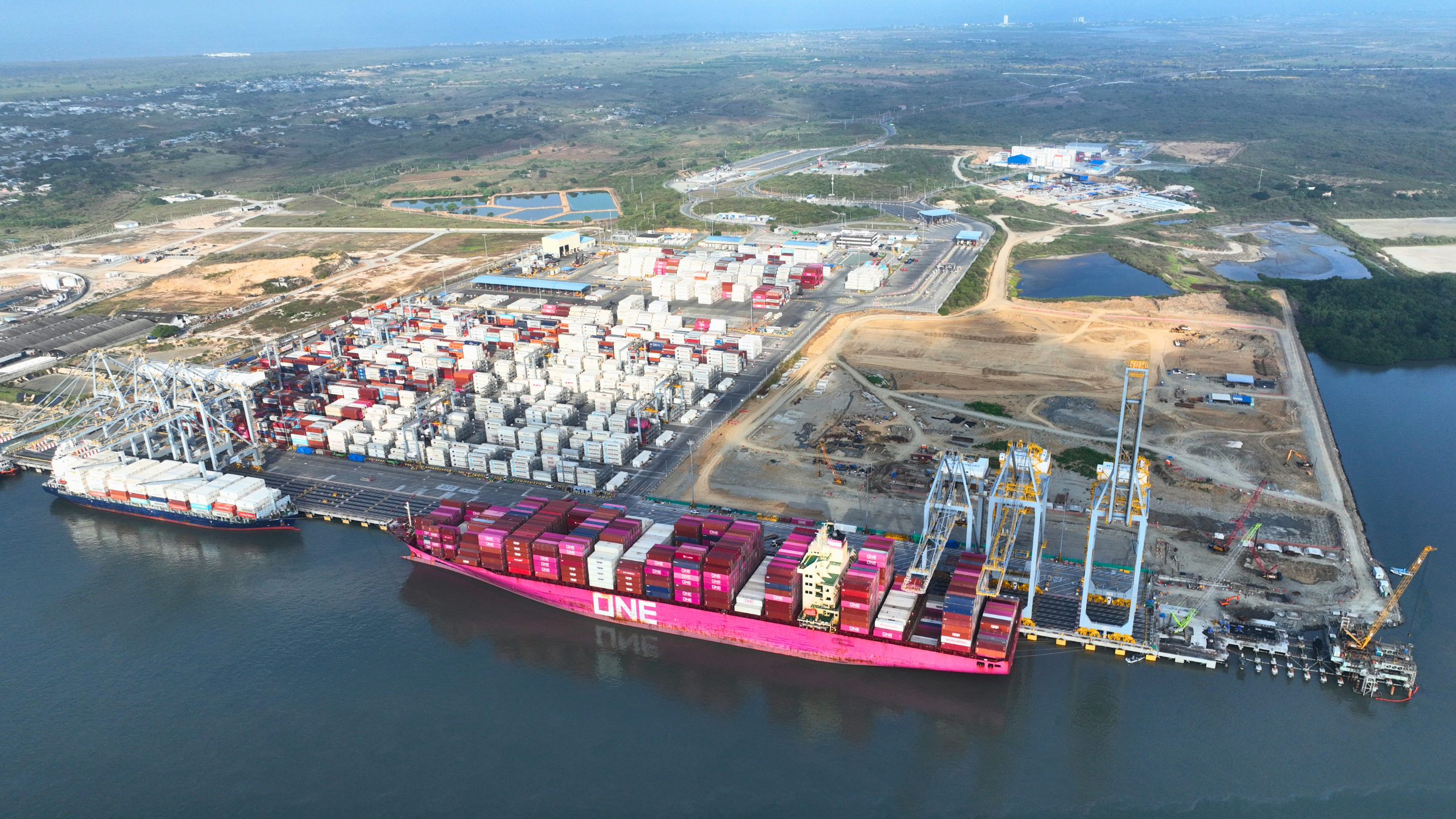 Port of Posorja in Ecuador with container ships, cargo containers, and terminal infrastructure.