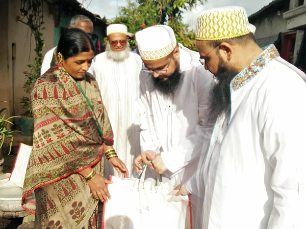 Members of the Bohra community distribute food to families in Kolhapur, India.