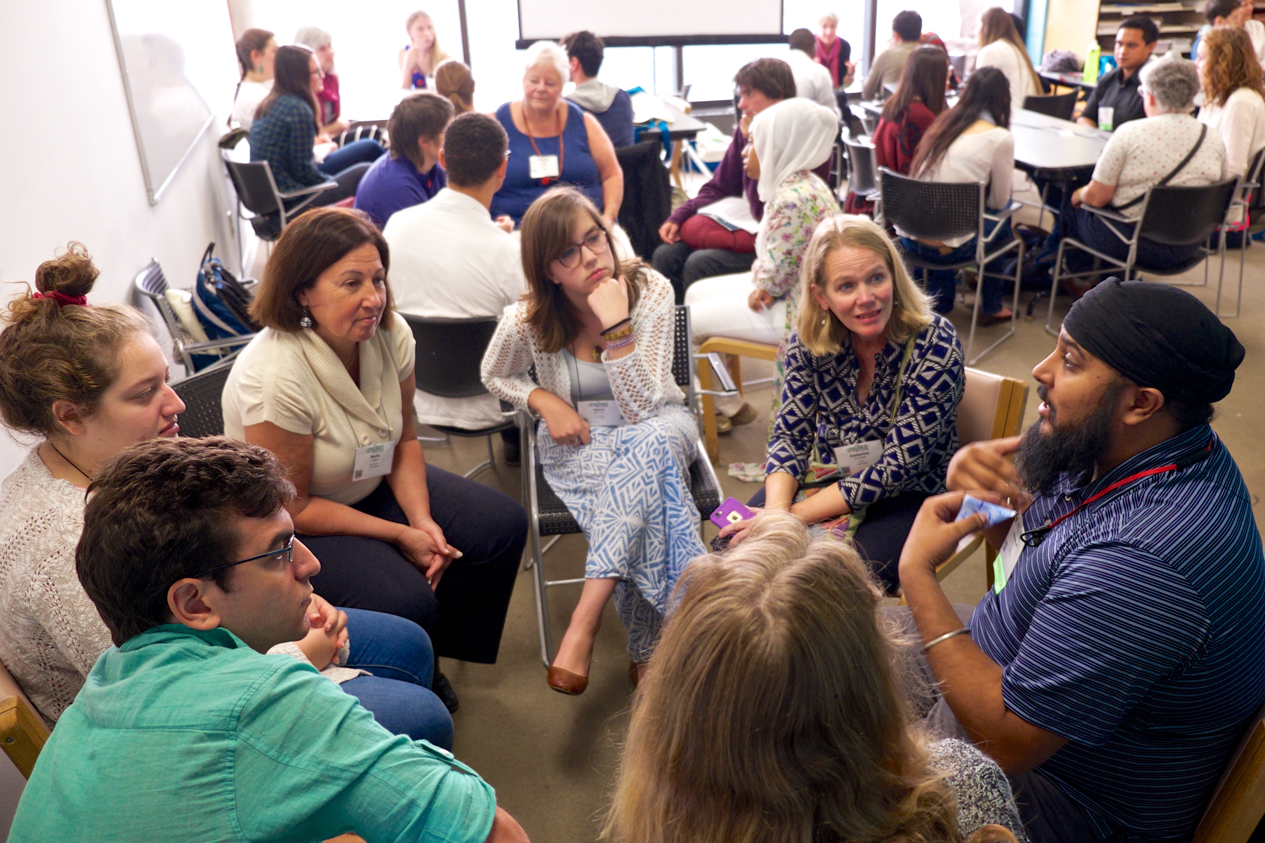 URI members from many countries gather in a circle to hear perspectives from one another's cultures and faith traditions.