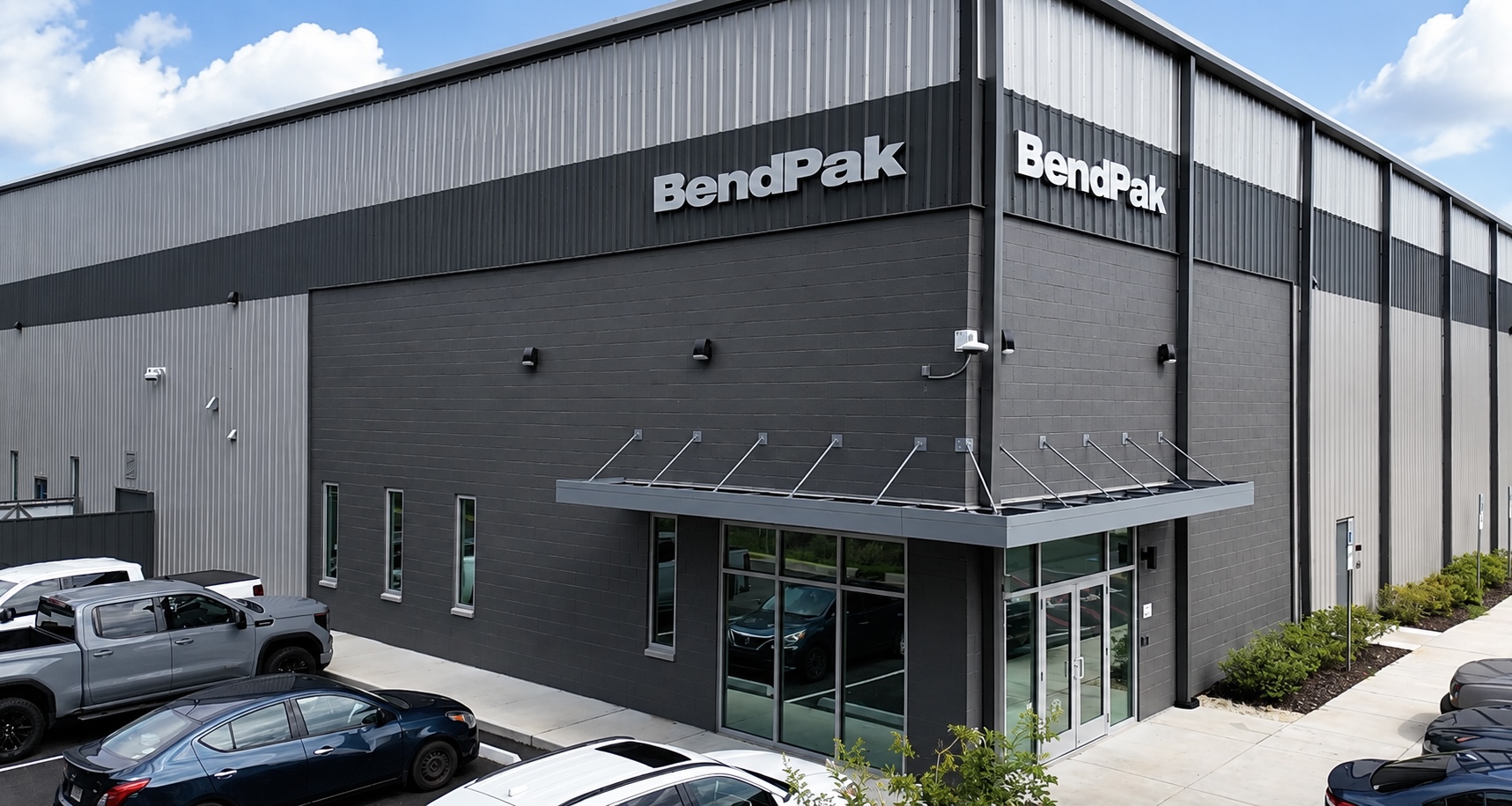 The exterior facade and main entrance of the large modern BendPak logistics and distribution facility in Alabama.