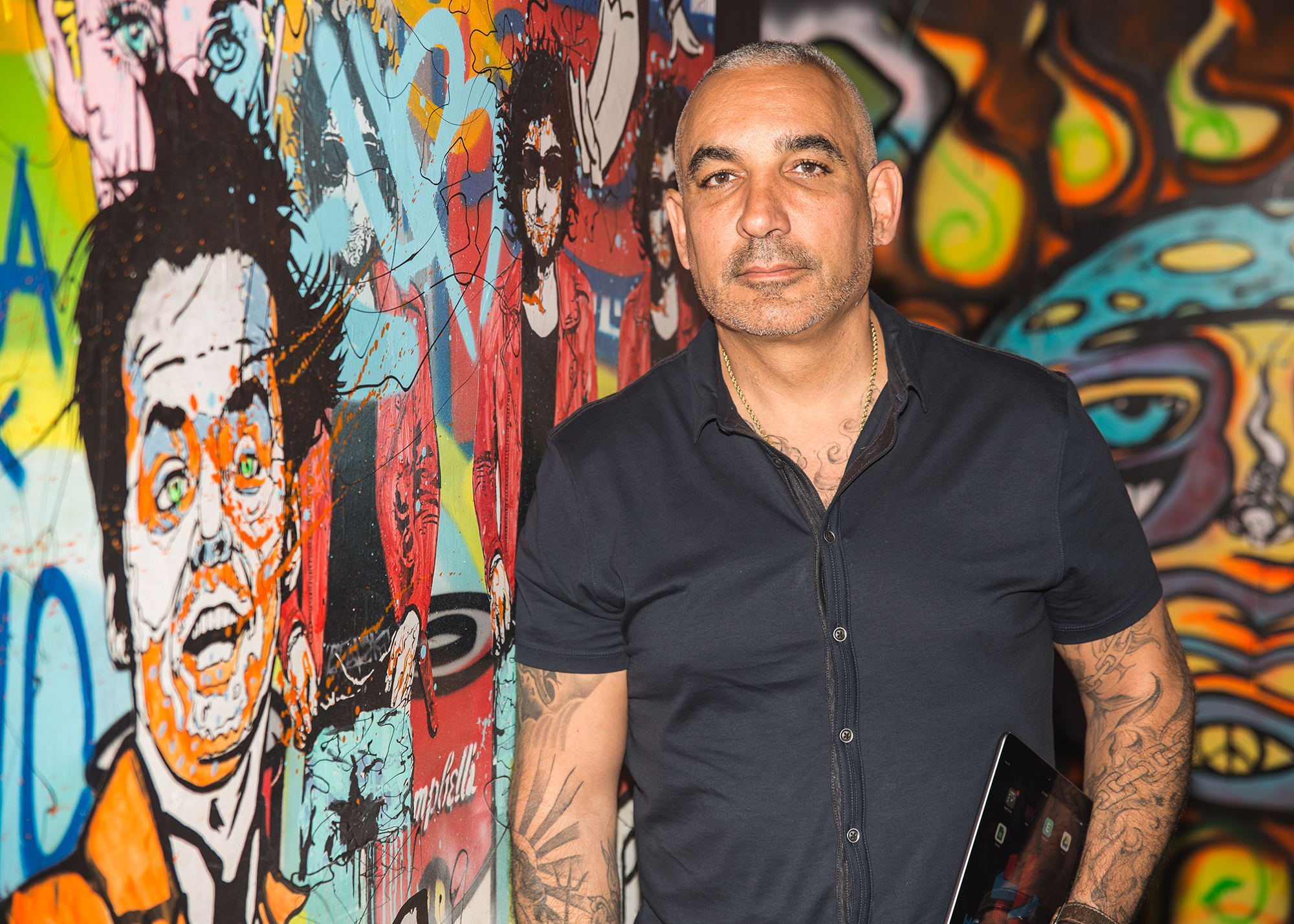 FilmOn TV CEO Alki David at his Hollywood office with a mural of Jack Nicholson and Bob Dylan by graffiti artist Alec Monopoly. Watch 1000s of movies and 600 channels at FilmOn.com 