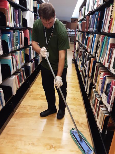 Stefan learning to mop floors as part of his co-op placement with Sodexo through Project SEARCH Toronto at Holland Bloorview Kids Rehabilitation Hospital.