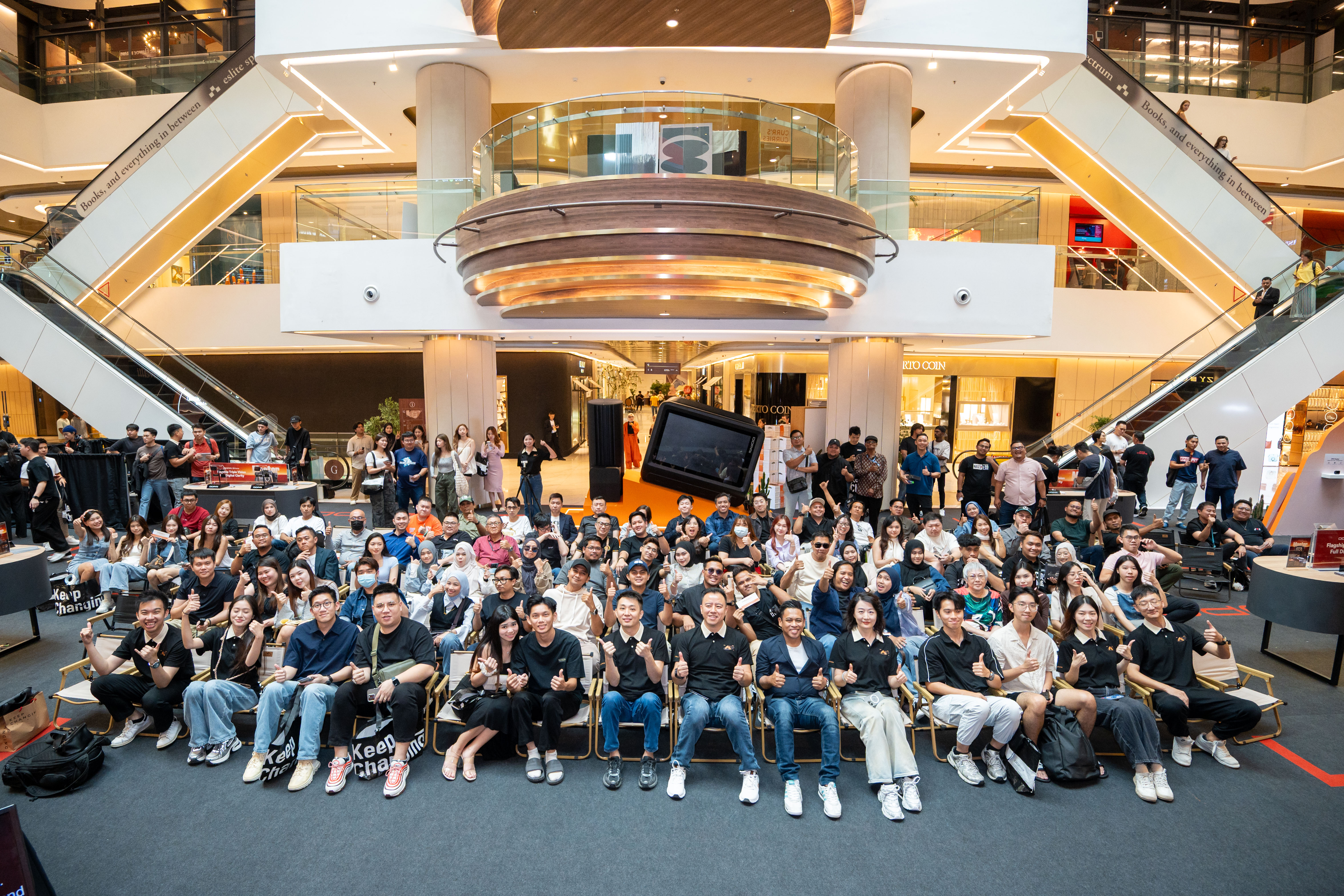 A group photo taken during the Malaysia launch event, celebrating teamwork and success.
