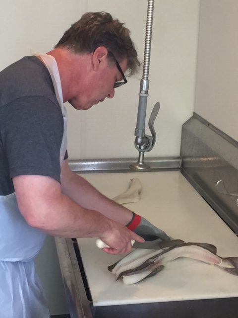 Senior Inspector Scott Albrecht begins work on a sample whole cod at NSF International’s new seafood services program office located at the Port of Everett in Everett, Washington.