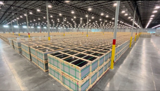 Stacks of modules fill a BroadRange warehouse specializing in solar panel handling