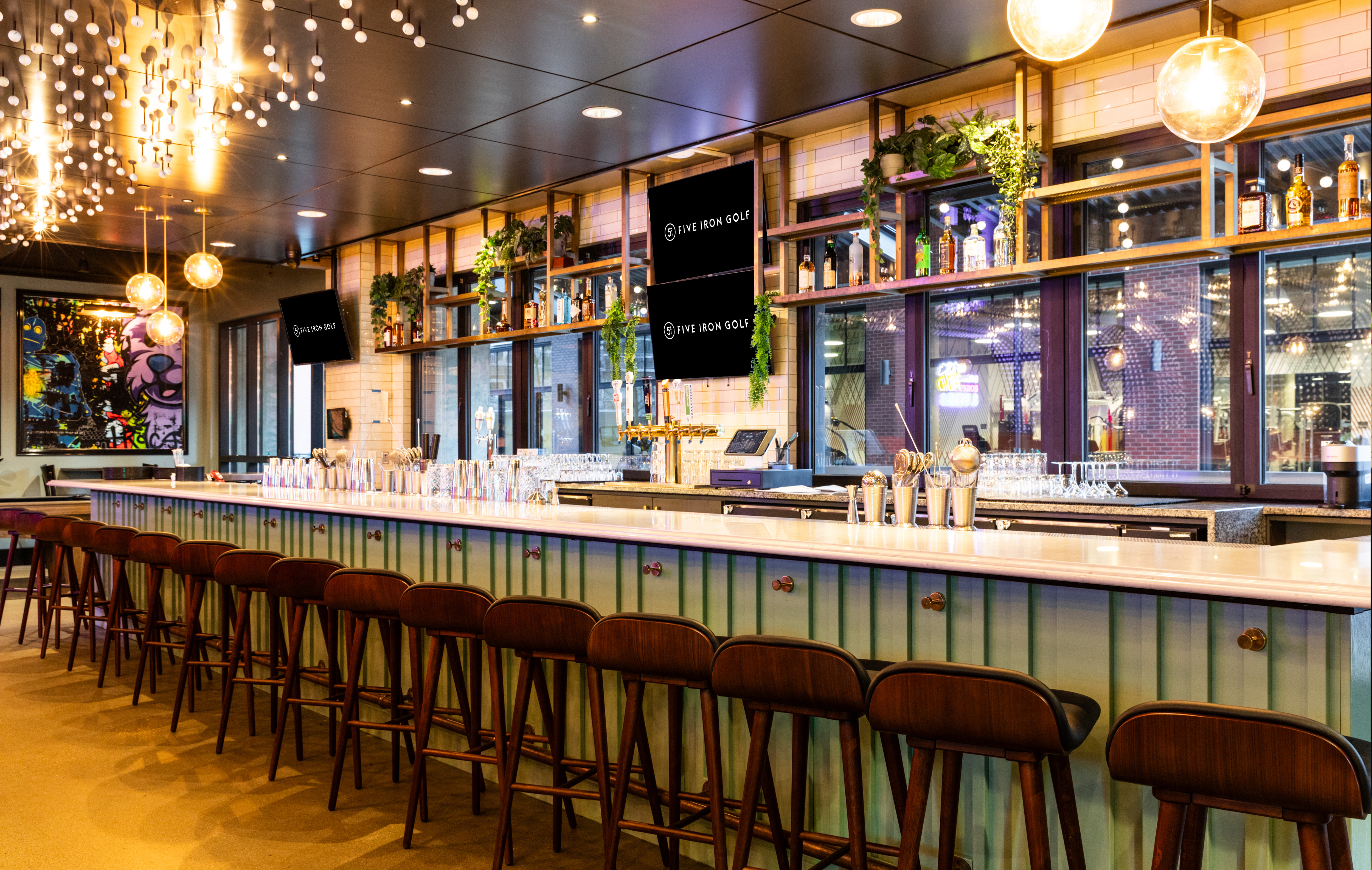 The Five Iron Golf Minneapolis bar offers a stunning space for post-round drinks, great food, and good times-blending sports, style, and hospitality seamlessly.