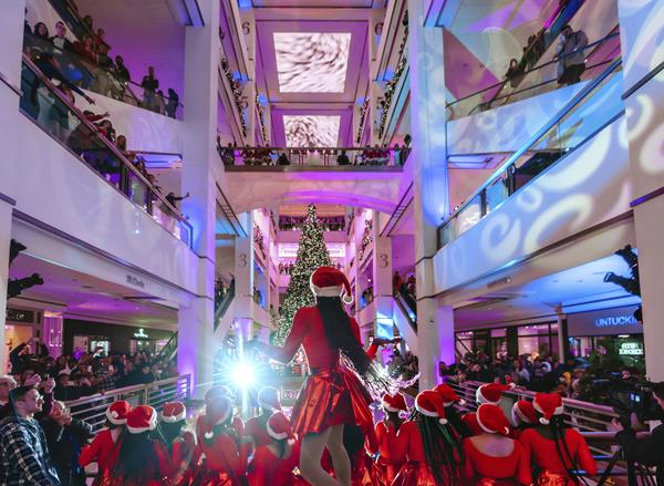 Dancers thrill the crowd with a pop-up performance of, "All I Want for Christmas is You" in front of the just-lit, 54" tall tree.