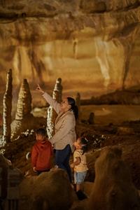 Family Exploring Cave Without A Name