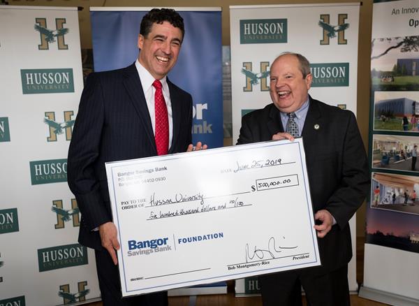 “Bangor Savings Bank has been a valued partner of Husson University for over 50 years. In 1966, it was the bank’s exceptional generosity along with other valued supporters, who helped make our campus at One College Circle possible,” said Robert A. Clark, MBA, PhD, president of Husson University. “Bangor Savings Bank’s recent gift of $500,000 for our new College of Business building will help the university provide our local business community with the educated workforce and business resources they need to grow our local economy.” (Pictured left to right), The President and CEO of Bangor Savings Bank Bob Montgomery-Rice presents a check for $500,000 to Husson University President Robert A. Clark, MBA, PhD.

