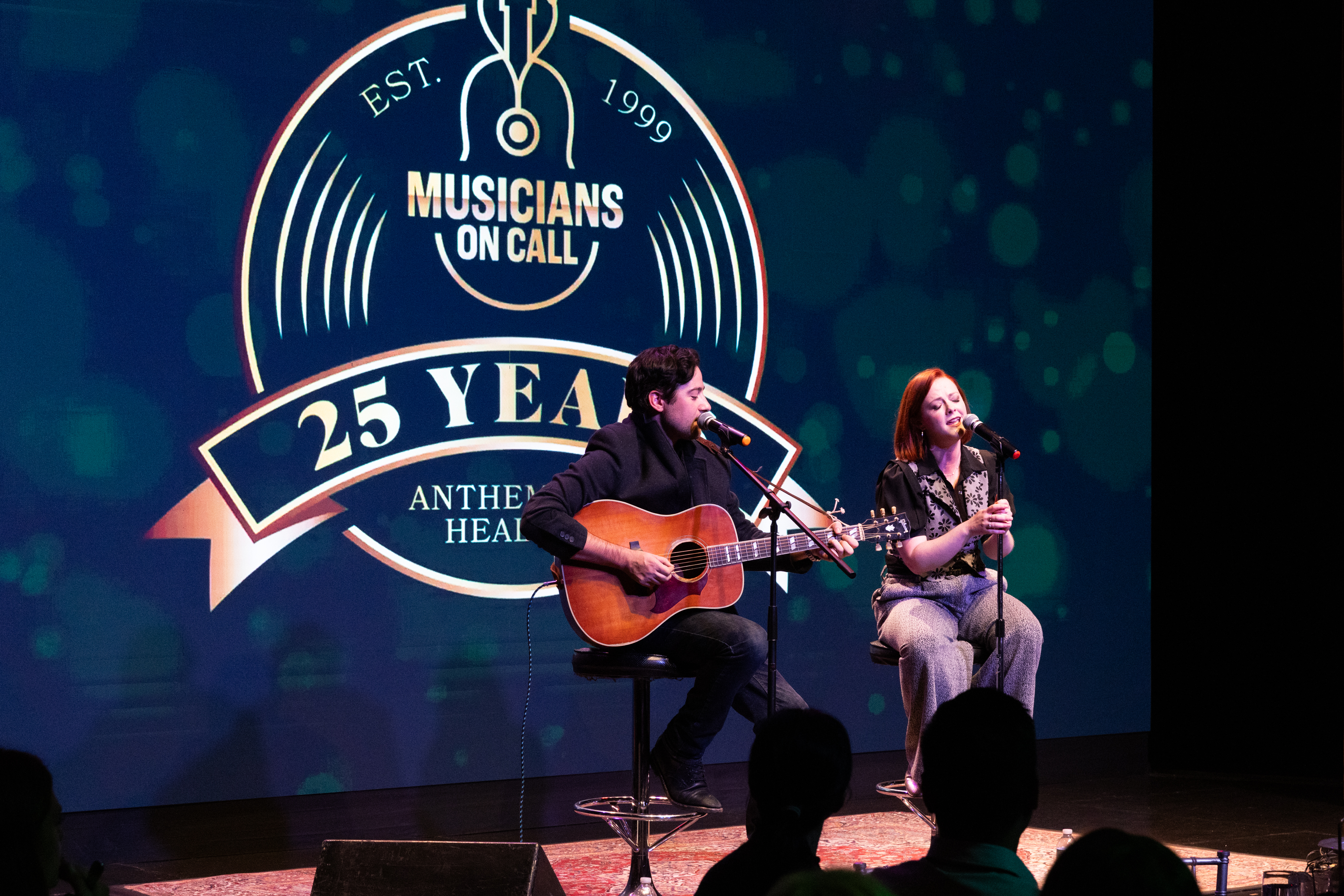 Alexis Babini and Katie Emerson perform during Musicians On Call's 