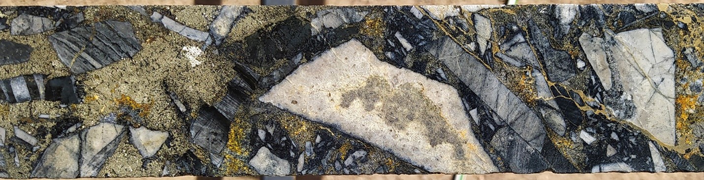 Typical gold-rich breccia mineralization at SFdLA: Tourmaline-sericite altered siltstone clasts supported in a pyrite-tourmaline-chalcopyrite matrix. SFDH-032, 78.7m. From a 1m sample that averaged 6.82 g/t gold, 137 g/t silver and 1.2 % copper. Photograph is of a selected interval and is not necessarily representative of mineralisation hosted throughout the property.