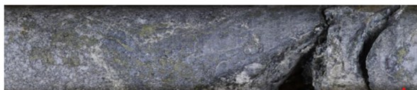 b) Sulphide. 199.8m depth. Quartz-chalcopyrite-molybdenite veinlet dissemination with sericite alteration.18.0m @ 0.64% Cu