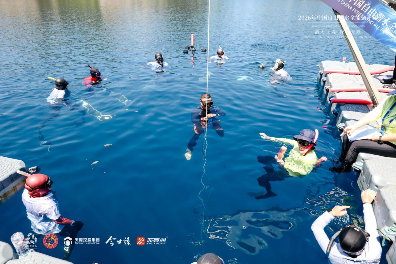Athletes competing in constant weight without fins at the Xiangshan mine lake with descent line and surface safety team in position