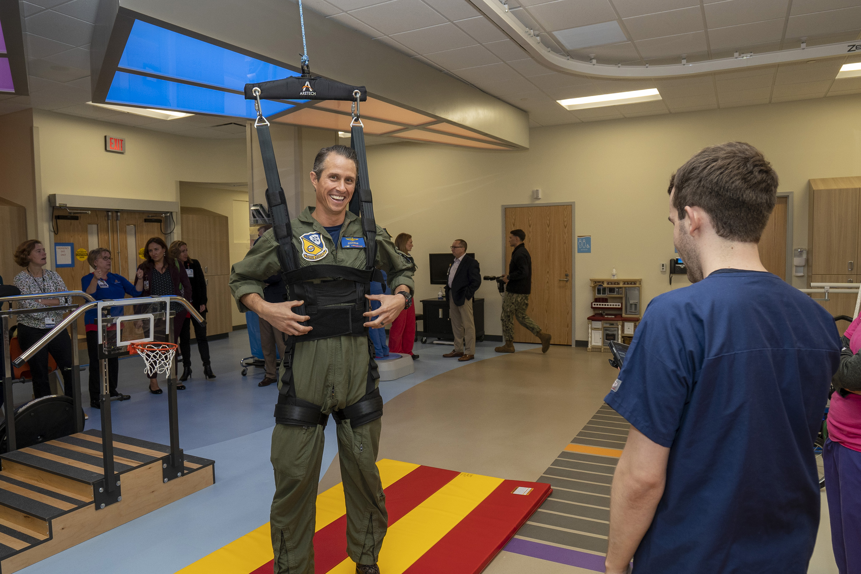 U.S. Navy Lt. Cmdr. Matt Suyderhoud, a former Blue Angel, demonstrates ZeroG technology during the grand opening of a newly renovated rehab unit at Children's Hospital of The King's Daughters.