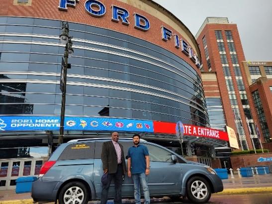 ModivCare Inc. (“ModivCare”) is providing much-needed, door-to-door transportation services to Michigan residents in Wayne, Oakland, and Macomb counties wishing to receive a COVID-19 vaccine from the mass vaccination site at Ford Field in Detroit. Pictured here in front of the Ford Field vaccination site is Donald Scott (left), Provider Relations Manager for ModivCare, and Mohammed (Ron) Haque (right), co-owner of M RUN LLC, which is the local transportation partner for ModivCare offering rides to local residents to/from the vaccination site.