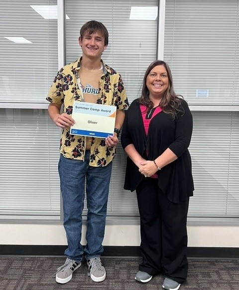Oliver Jernigan accepts his Summer Camp Award from Troy Assistant Branch Manager Amanda Cranford.