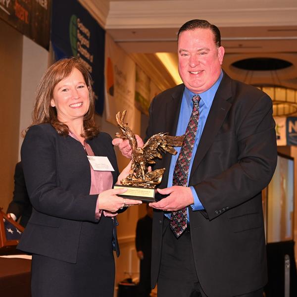 Minuteman Press Westfield franchise owner Jim Mooney accepts the Small Business of the Year Award from Elizabeth Manzo, Chairperson of the GRCC.