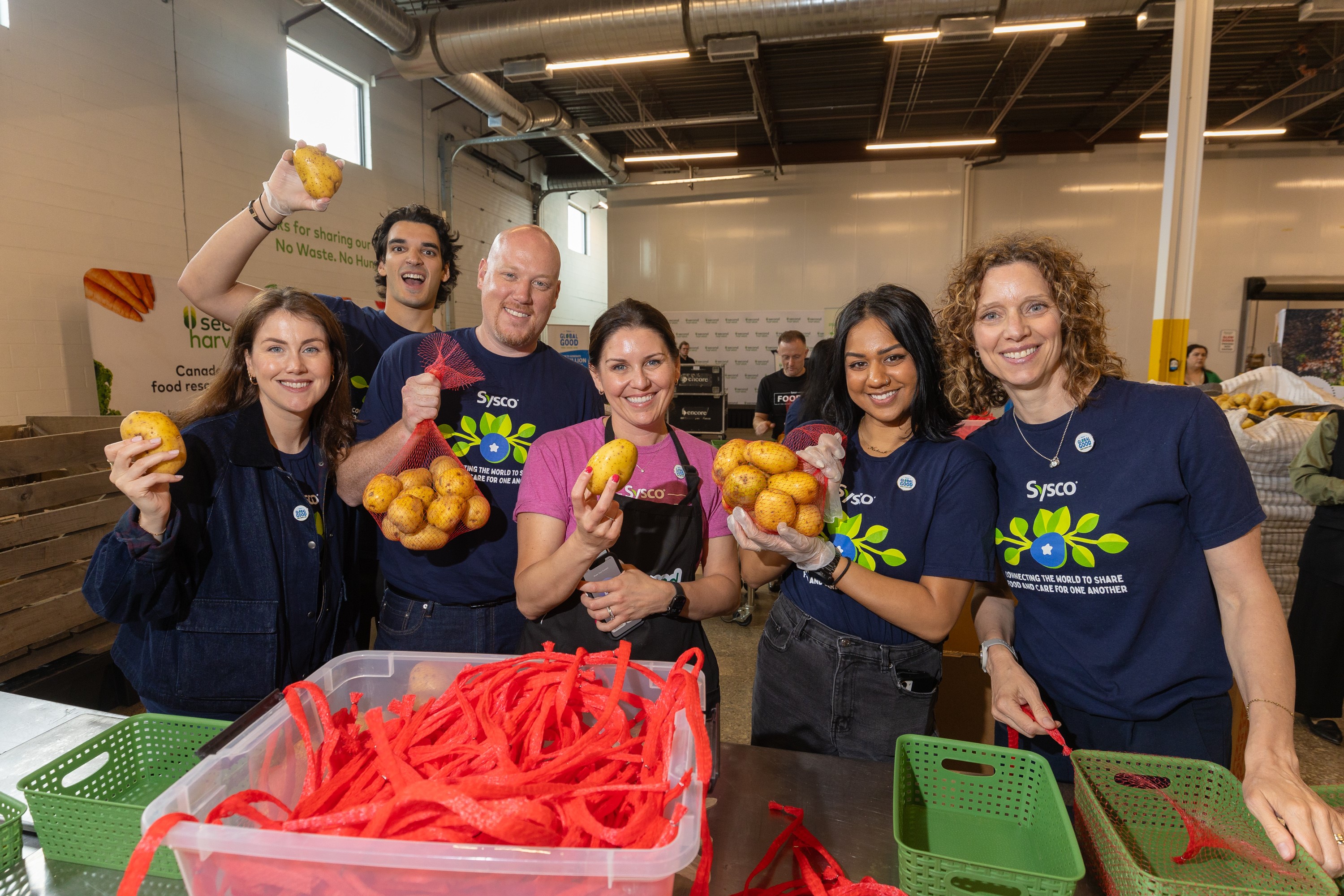 Sysco colleagues sort food for Second Harvest, celebrating a 26-year partnership and a a $50,000 donation made by Sysco Canada to the organization.