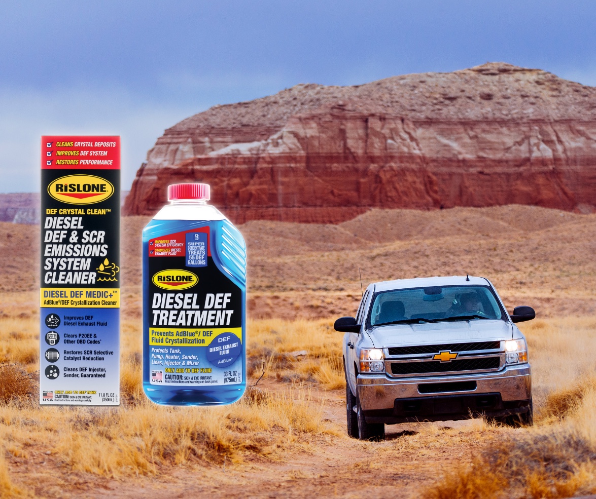 A pickup truck driving in the desert with Rislone Diesel DEF Cleaner and DEF Treatment.
