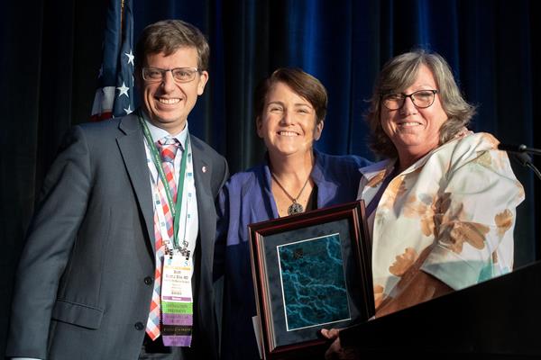 Judith F. Baumhauer, MD, MS, MPH, (center) accepts the 2019 Women’s Leadership Award from Scott J. Ellis, MD, (left) president the Orthopaedic Foot & Ankle Foundation and the 2018 Women’s Leadership Award recipient, Ruth L. Thomas, MD, (right).
