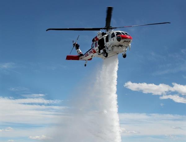 A CAL FIRE Hawk demonstrates its ability to drop a concentrated plume of water from its 3,785-liter (1,000-gallon) external water tank. United Rotorcraft is the only completion center approved by Sikorsky to modify Black Hawk helicopters to the FIREHAWK configuration.