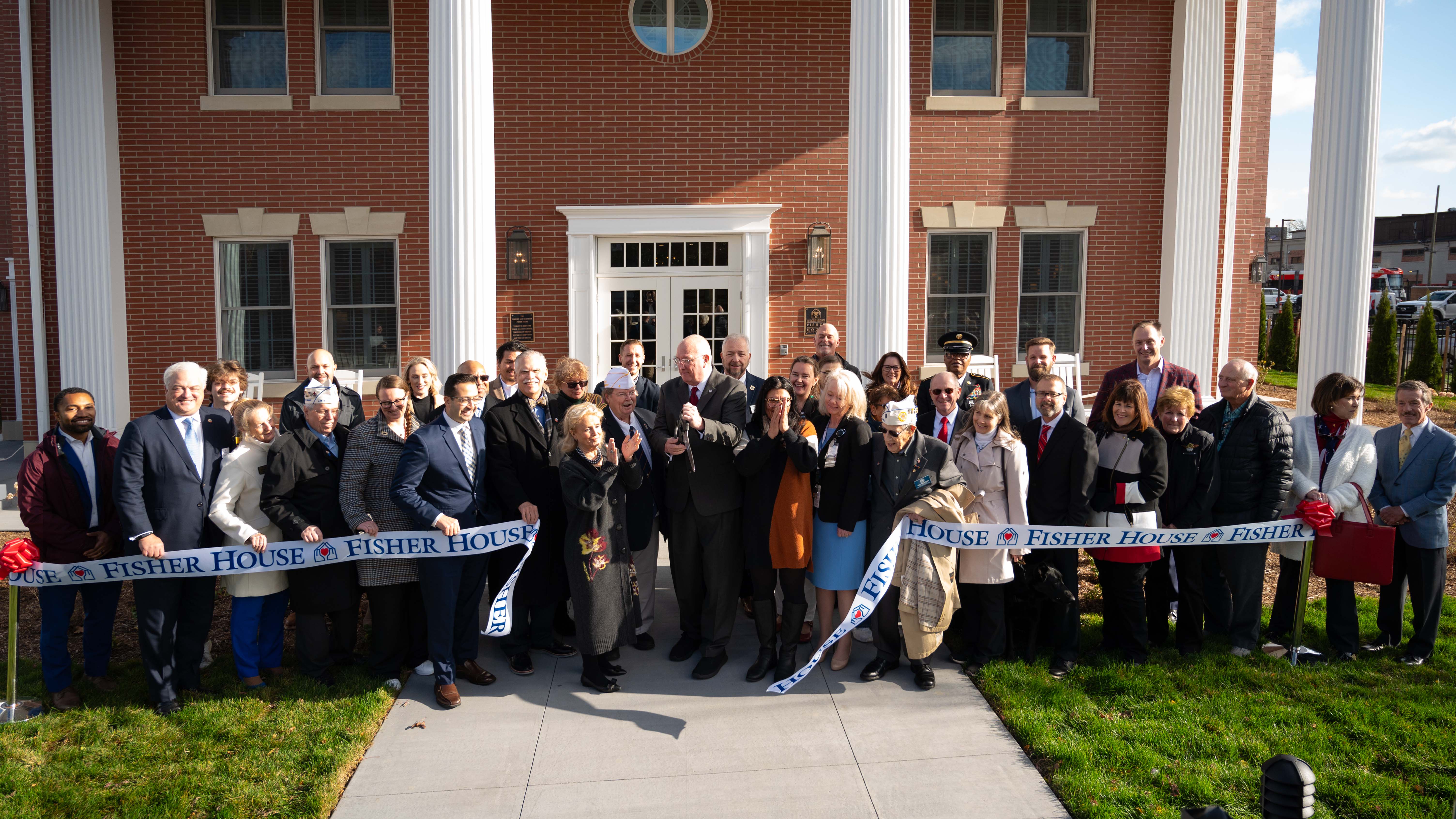 Supporters cut the ribbon on the new Fisher House at the John D. Dingell VA Medical Center in Detroit, MI