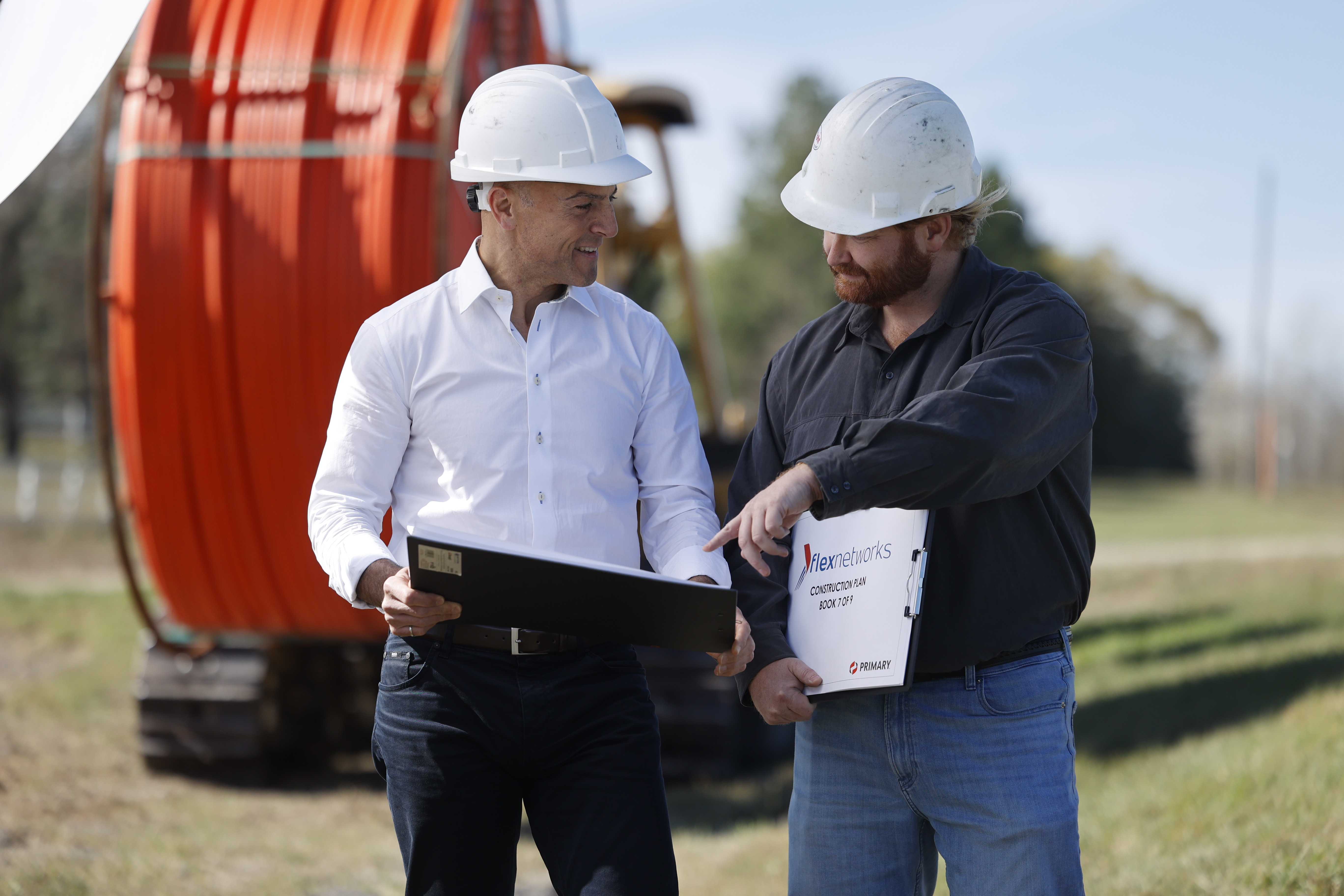 FlexNetworks leadership members review fibre construction plans during a network build. The company continues to invest in expanding capacity and strengthening connectivity across Central Canada.