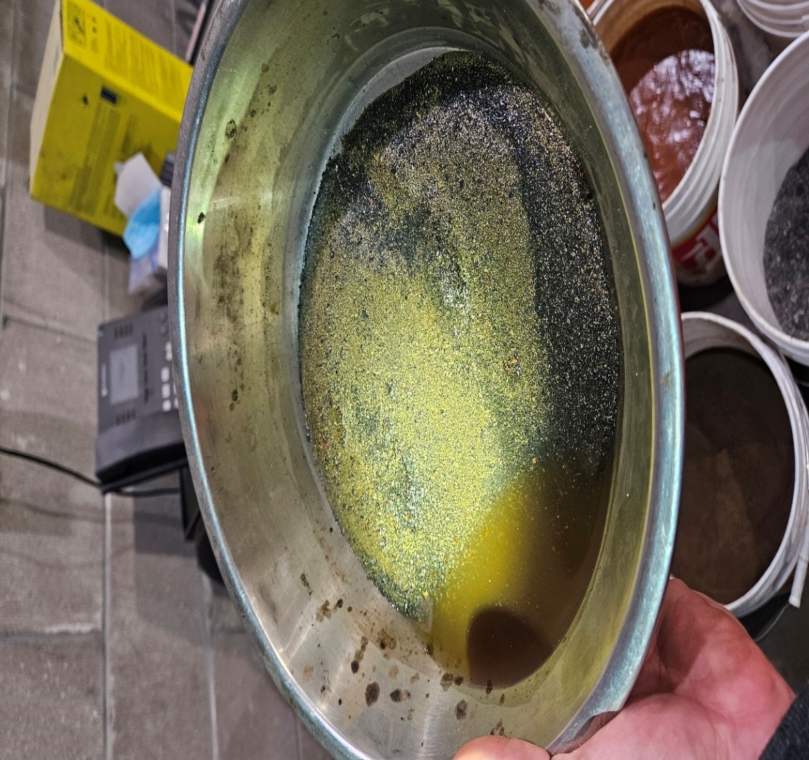 Photograph of sample concentrate material with coarse visible gold collected as part of the recovery and cleanup program at Madsen Mine.