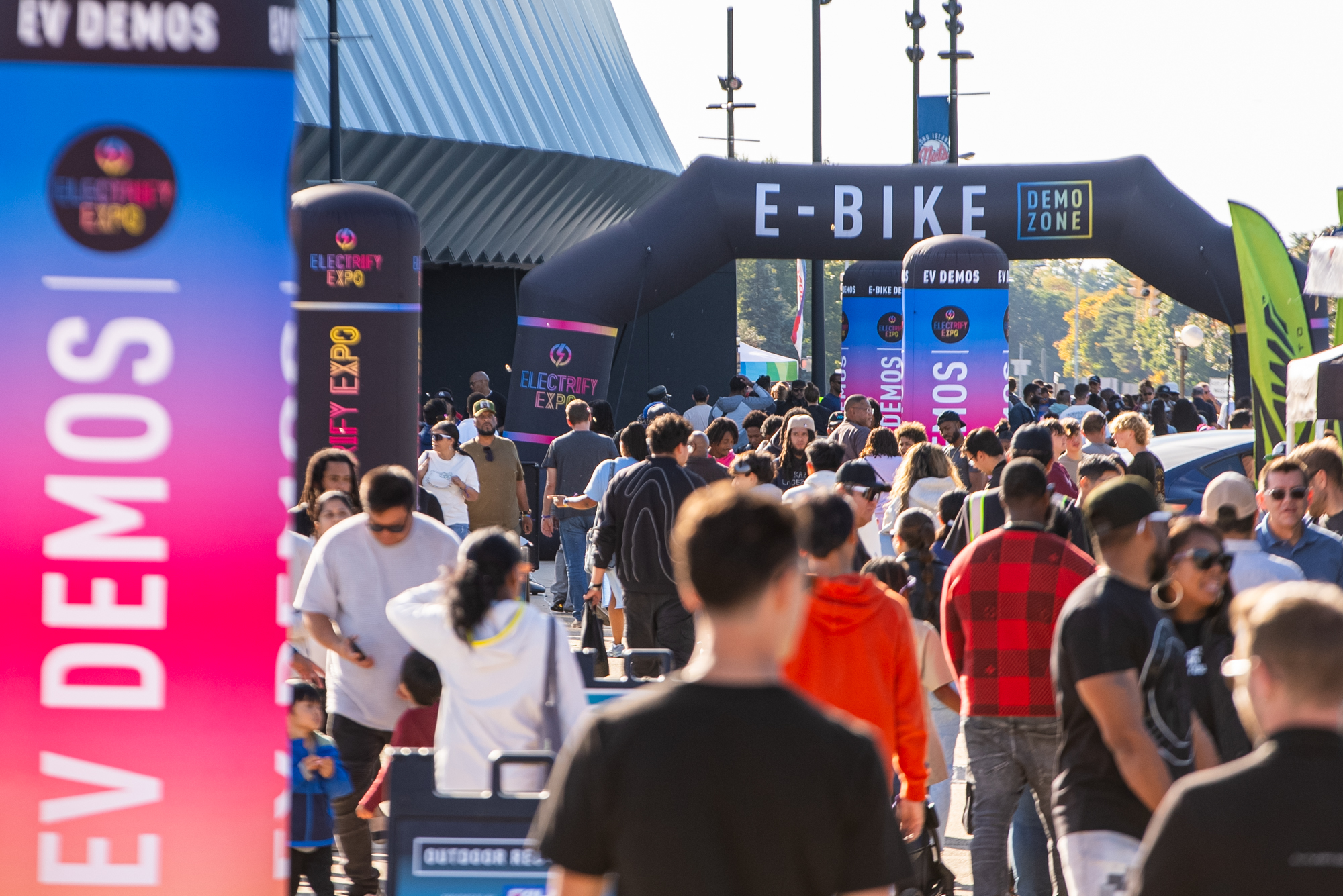 Attendees explore Electrify Expo, experiencing the latest electric vehicles and innovative technology.