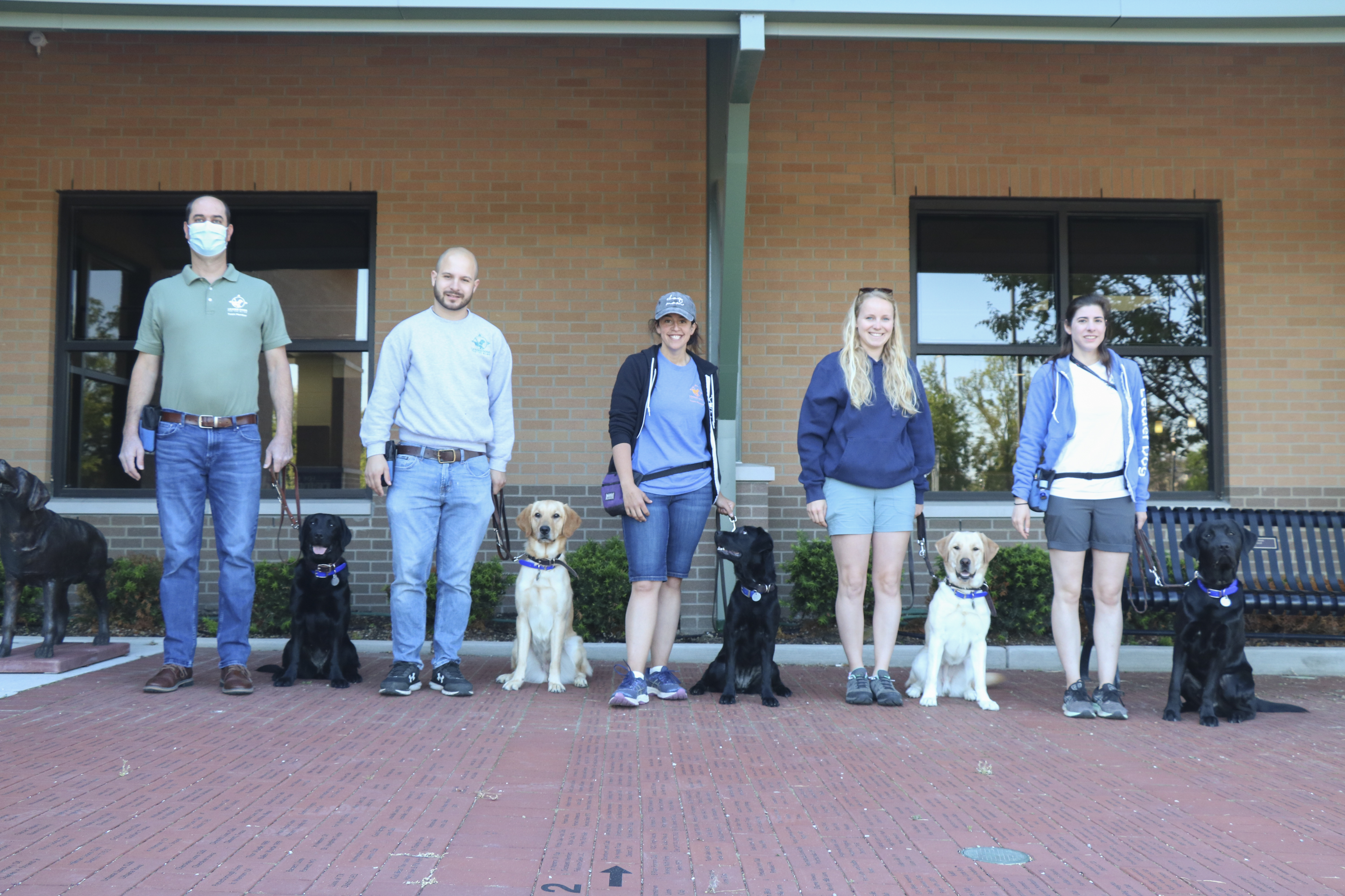 The dogs transported on June 1 to CNIB, from left to right, were Kiki, female Labrador retriever;  Rockette, female golden/Labrador retriever cross; Harper, female Labrador retriever; Nova, female Labrador retriever; and Quebec, male Labrador retriever. They are being handled by, from left to right, Jeff Stein, Leader Dog manager of canine care and Leader Dog Guide Dog Mobility Instructors David Linares, Alyssa Ozrovitz, Heidi Vollrath and Monica Swanseger.