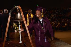 Graduate Rosa Rainey rings the bell during commencement exercises for HII’s Newport News Shipbuilding Apprentice School held Saturday, March 18, 2023. (Photo by Lexi Whitehead/HII)